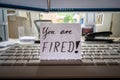 Desk with notice of termination of employment on a notepad