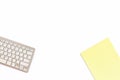 Desk in the office with a keyboard and a yellow Notepad on a white background. Top view with copy space. Royalty Free Stock Photo