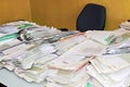 Desk in the office with stacks of paperwork.