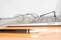 Desk with open notepad, pen, eye glasses, nicely placed on office table. Top view with copy space. Business still life concept Royalty Free Stock Photo