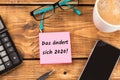 Desk with paper and german text das ÃÂ¤ndert sich 2020, in english that will change in 2020 Royalty Free Stock Photo