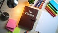 A desk setup with a notebook titled Tax Planning Royalty Free Stock Photo