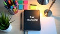 A desk setup with a notebook titled Tax Planning Royalty Free Stock Photo