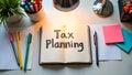 A desk setup with a notebook titled Tax Planning Royalty Free Stock Photo