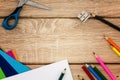 Desk with sharpener, compass, construction paper and colored pencils Royalty Free Stock Photo