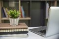 Desk for student education concept. Planner Book, laptop, plant, and pencil for study for exam placed on white School table with Royalty Free Stock Photo