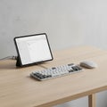 On the desk is a tablet with a stand displaying a plain white interface Royalty Free Stock Photo