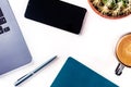 Desk, top view on a white background. Coffee, notebook, phone, plant Royalty Free Stock Photo