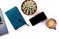 Desk, top view on a white background. Coffee, notebook, phone, plant Royalty Free Stock Photo