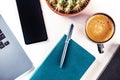 Desk, top view on a white background. Coffee, notebook, phone, plant Royalty Free Stock Photo