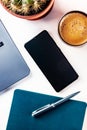 Desk, top view on a white background. Coffee, notebook, phone, plant Royalty Free Stock Photo