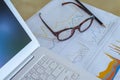 desk workplace, closeup eyeglasses, laptop, pencil and report gr