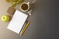 Desk workspace, grey workspace with cup of coffee, empty notebook and plant on dark table. Cup of coffee and space for text. flat Royalty Free Stock Photo