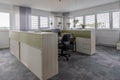 Desks are located in a modernly furnished office