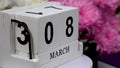 Desktop calendar with the date of March 8 and a bouquet of beautiful flowers.