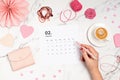 Desktop with calendar for february and pink accessories. Saint Valentine, home office, social media blog