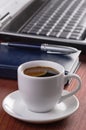 Desktop with coffee cup, opened laptop computer, Royalty Free Stock Photo