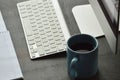 Desktop computer, cup of coffee and note pad on the office desk Royalty Free Stock Photo