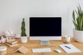 Desktop computer with mockup on wooden desk with books, keyboard Royalty Free Stock Photo