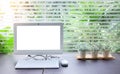 Desktop computer with workspace background and small bucket of artificial flowers near transparent glass window can looking at Royalty Free Stock Photo