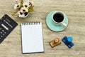 Desktop : empty notebook, wooden stamp with cup of coffee, calculator on wood table Royalty Free Stock Photo