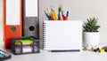 Desktop layout planner. Folders with documents, paper clips, pencils and pens, an empty notepad with a place to insert text on the Royalty Free Stock Photo