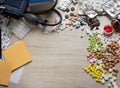 Desktop of a medical worker. Scattered pills of various shapes in color, a medical tonometer and paper with a pencil Royalty Free Stock Photo