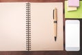 Desktop with notepad and smartphone Royalty Free Stock Photo