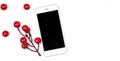 Desktop technology modern smartphone concept on white isolated background with decorative red berries Royalty Free Stock Photo