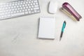 Desktop top view. Blank notepad with pen, keyboard, mouse and stapler on the desktop Royalty Free Stock Photo