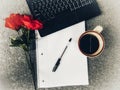 Desktop View Of Laptop Computer, A Cup Of Coffee, Notebook And Pen With A Red Rose On The Side, Home Office