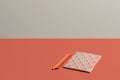 Desktop in vivid coral notebook with Renaissance pattern in live coral background