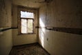 Desolate abandoned bathroom with sunlight shining through window