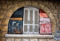 Desolate arch window of an old stone house