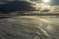 Desolate empty, icy road and harsh sunlight Royalty Free Stock Photo