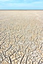 Desolate landscape with cracked ground at the seashore Royalty Free Stock Photo