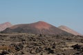 A desolate landscape with a large volcano on a desert island