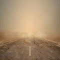 Desolate road stretches forward into a blinding dust storm Royalty Free Stock Photo