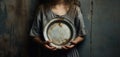 a poor girl holding a empty plate. child hunger concept. poverty and hunger concept. beggar, begging Royalty Free Stock Photo