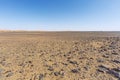 Desolate stone desert in front of the sand dunes of Erg Chebbi Royalty Free Stock Photo