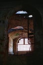 Desolate vault and window, letting sunlight in ruined interior