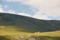 Desolated green mountains landscape with lonely farm house Royalty Free Stock Photo