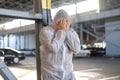 Despair healthcare worker in white covid protective overalls. Tired Male caucasian doctor grabs his head cower in depression