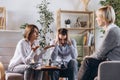 Unhappy married couple, sad, depressed man and woman meeting with doctor, psychologist to solve family problem. Royalty Free Stock Photo