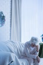 Despair senior woman on sofa Royalty Free Stock Photo