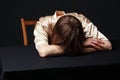 Despair. Woman is lying on the table, head on the hands Royalty Free Stock Photo