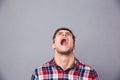 Despaired angry man in plaid shirt looking up and screaming Royalty Free Stock Photo