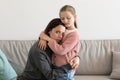 Despaired sad european millennial mom hugging little girl, daughter calms woman in living room Royalty Free Stock Photo