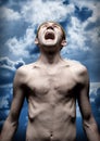 Despaired screaming man against dramatic sky Royalty Free Stock Photo