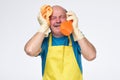 Desparate hispanic man with cleaning equipment is tired of household chores. Royalty Free Stock Photo